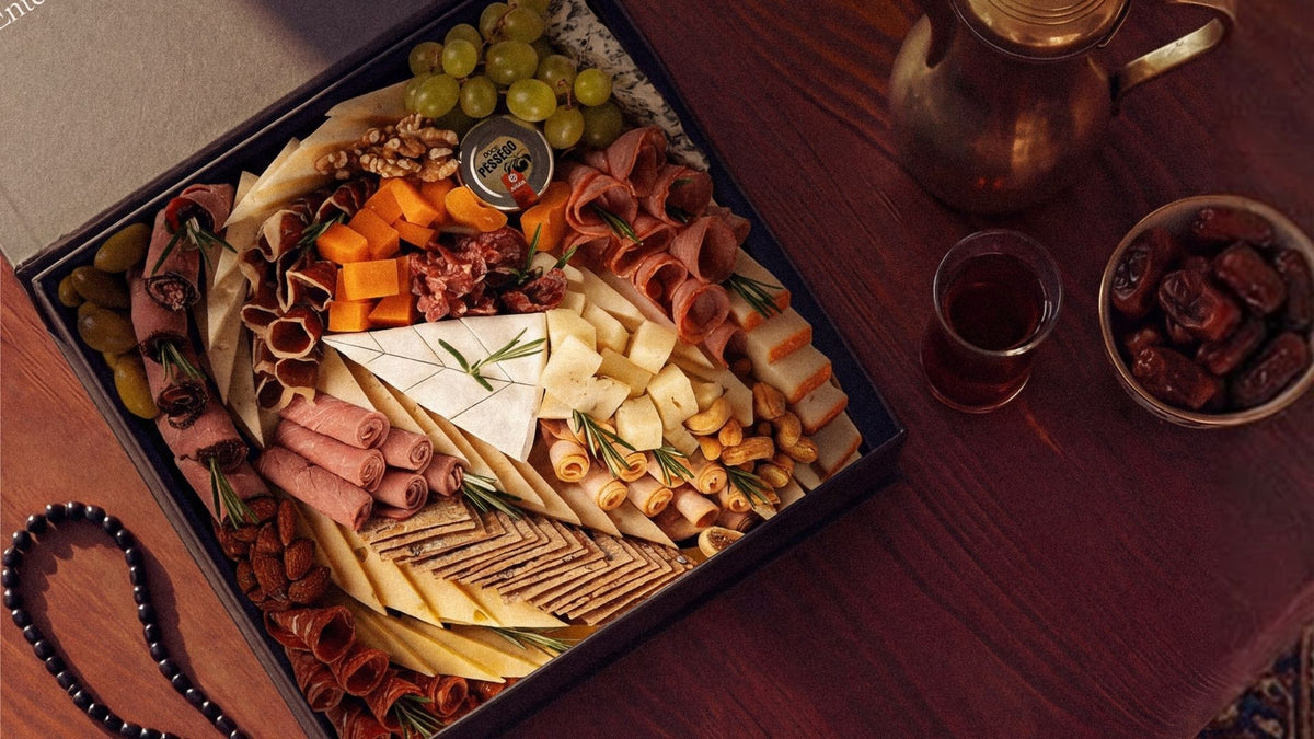 The Cheeseroom artisanal cheese platter featuring a personalised selection of European cheeses, halal charcuterie cold cuts, cured meats, olives, grapes, nuts, and artisanal crackers, styled on a wooden table with elegant gourmet accompaniments. A premium cheese platter Dubai, ideal for luxury cheese gifts, charcuterie platter Dubai, gourmet hosting, corporate gifting UAE, cheese board delivery Dubai, and premium cheese and charcuterie platters.